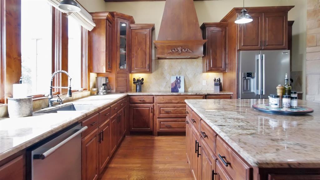 7421 Dawn Avenue Pilot Point, TX 76258 - Photo 15 of 40 a kitchen with stainless steel appliances granite countertop a sink and a counter space