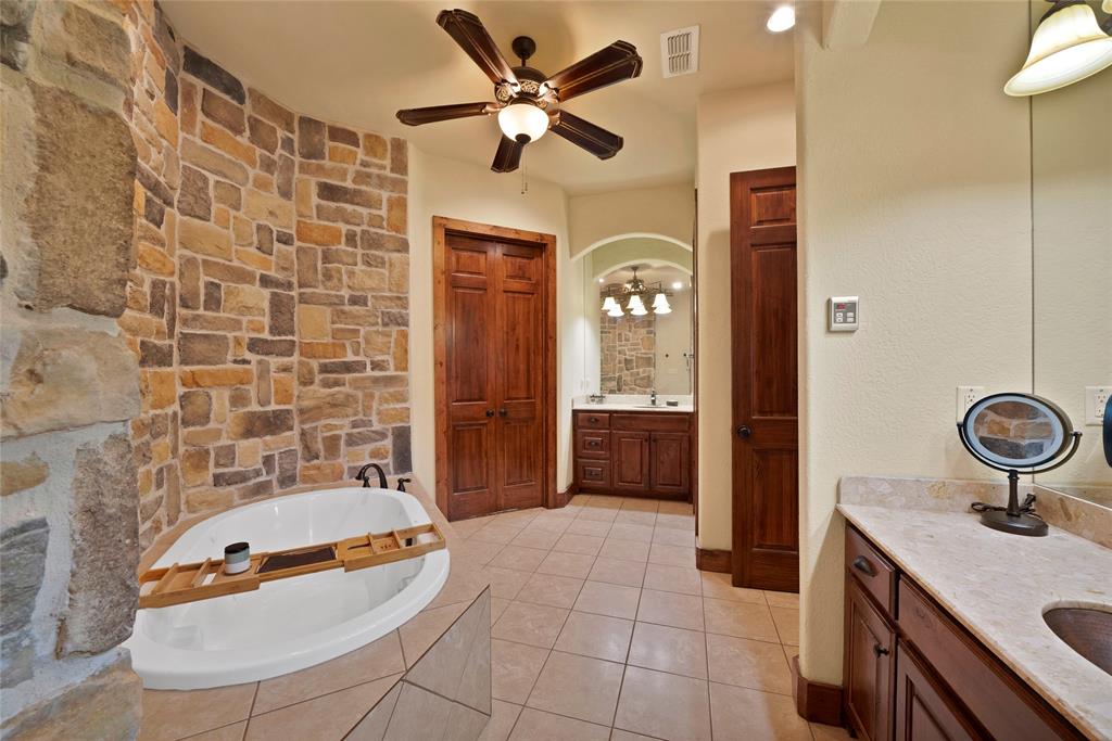 7421 Dawn Avenue Pilot Point, TX 76258 - Photo 22 of 40 a bathroom with a sink a toilet a mirror and shower