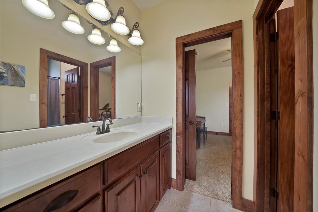 7421 Dawn Avenue Pilot Point, TX 76258 - Photo 26 of 40 a bathroom with a double vanity sink and a mirror