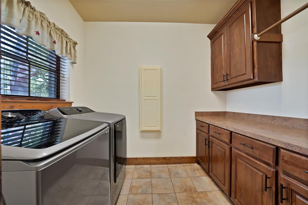 7421 Dawn Avenue Pilot Point, TX 76258 - Photo 29 of 40 a kitchen with wooden cabinets and a stove top oven