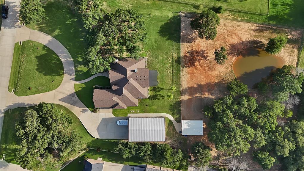 7421 Dawn Avenue Pilot Point, TX 76258 - Photo 5 of 40 an aerial view of a house with a garden and swimming pool