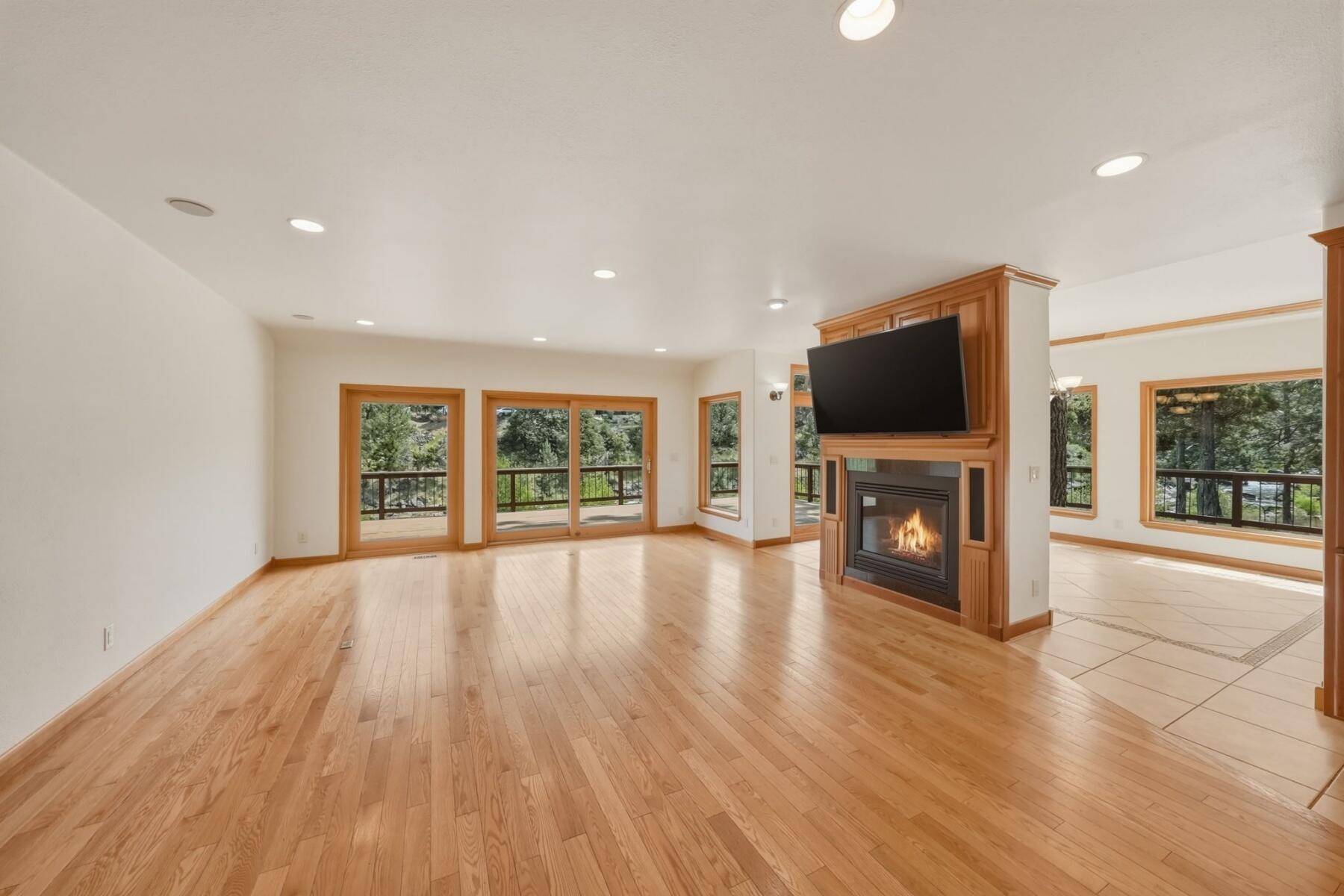 637 Northwest Silver Buckle Road Bend, OR 97703 - Photo 7 of 68 a view of empty room with wooden floor and fireplace