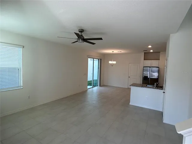 a view of a livingroom with a ceiling fan and a window