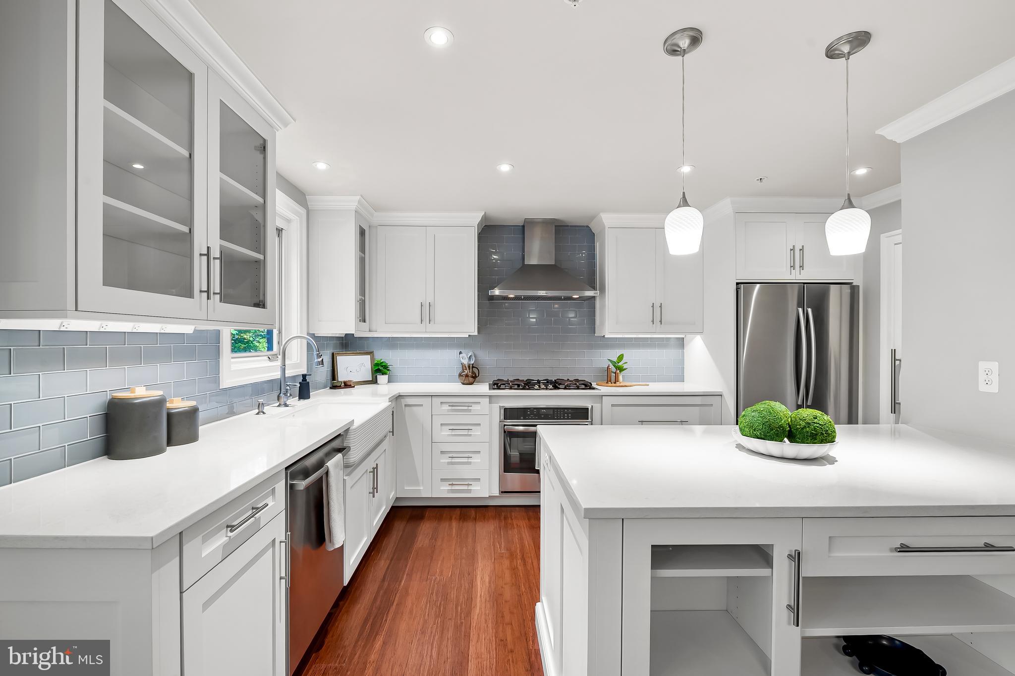 a kitchen with a sink a stove a refrigerator and cabinets