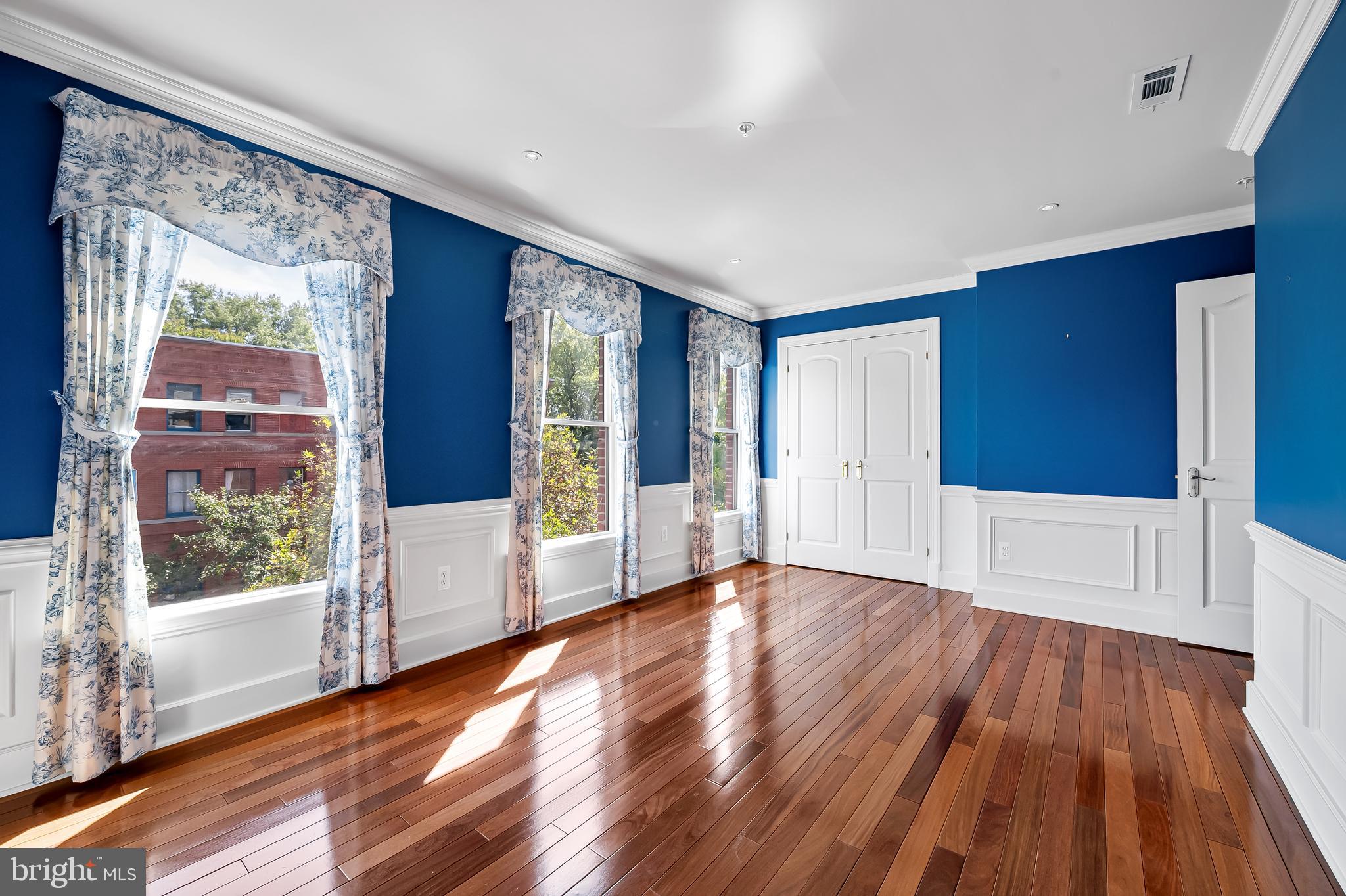 254 Robert Street Baltimore, MD 21217 - Photo 23 of 31 a view of an empty room with wooden floor and a window