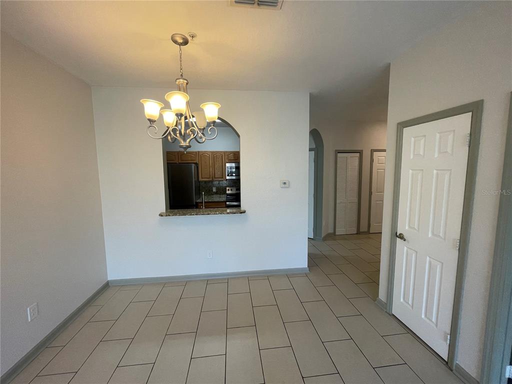 13548 Turtle Marsh Loop, Unit 427 Orlando, FL 32837 - Photo 17 of 34 a view of a hallway with a chandelier
