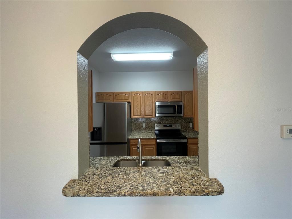 13548 Turtle Marsh Loop, Unit 427 Orlando, FL 32837 - Photo 18 of 34 a room with a table and chairs