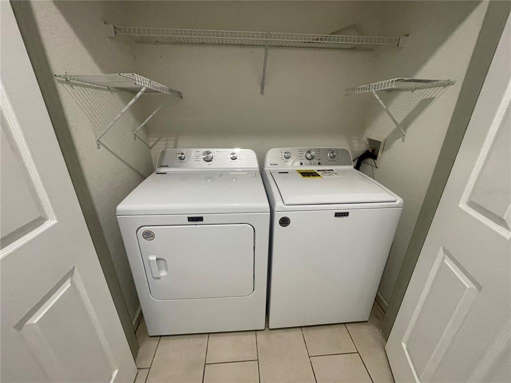 13548 Turtle Marsh Loop, Unit 427 Orlando, FL 32837 - Photo 23 of 34 a utility room with dryer and washer