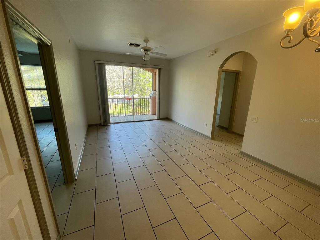 13548 Turtle Marsh Loop, Unit 427 Orlando, FL 32837 - Photo 25 of 34 wooden floor in an empty room with a window