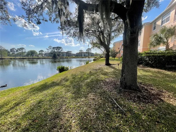 a view of a lake with a house in the background