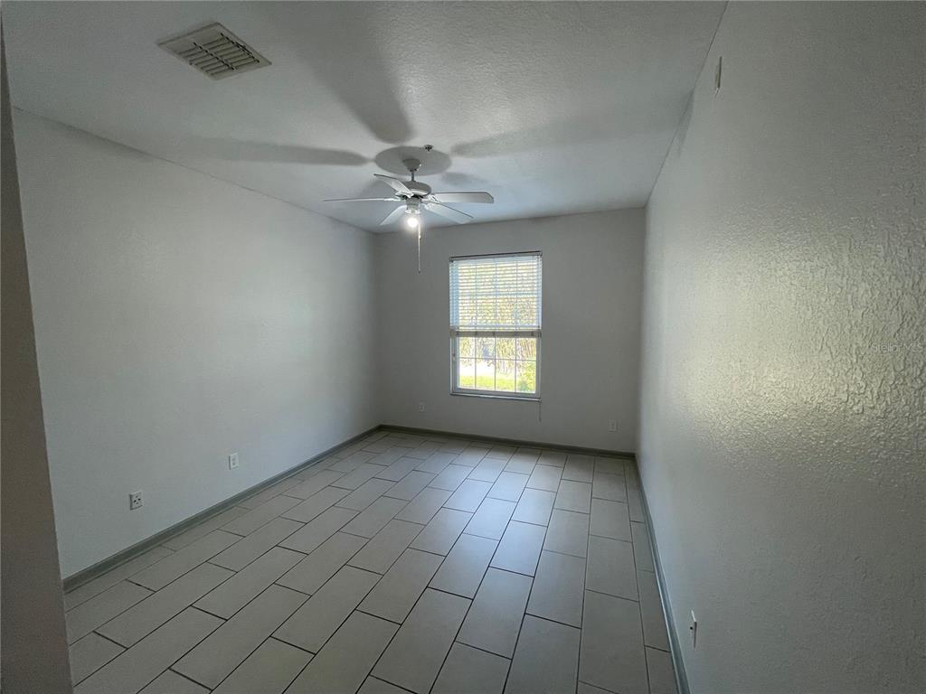13548 Turtle Marsh Loop, Unit 427 Orlando, FL 32837 - Photo 7 of 34 an empty room with windows and fan