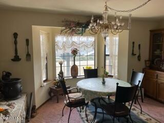 23381 Angus Court Tehachapi, CA 93561 - Photo 4 of 8 a view of a dining room with furniture wooden floor and chandelier