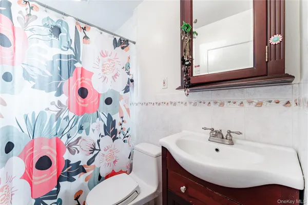 a bathroom with a sink toilet and a mirror