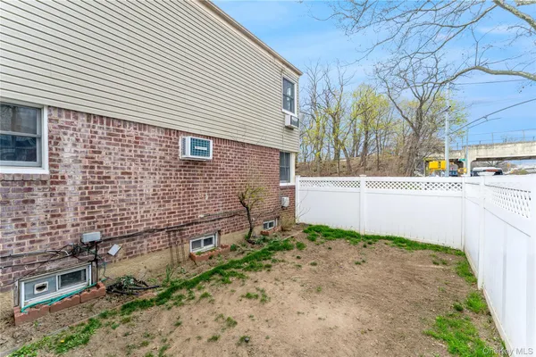 a view of house with backyard and wooden fence