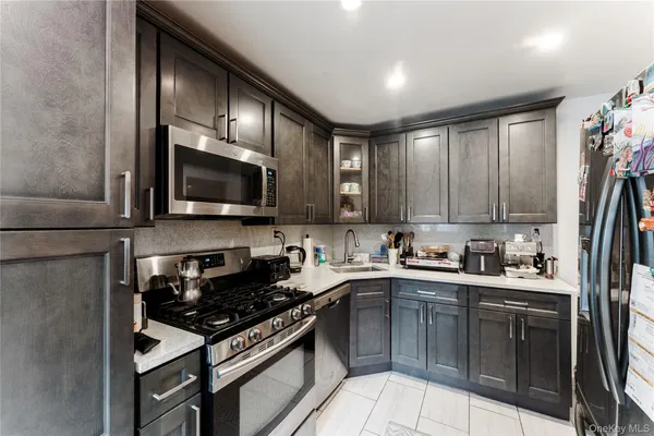 a kitchen with a sink a stove and cabinets
