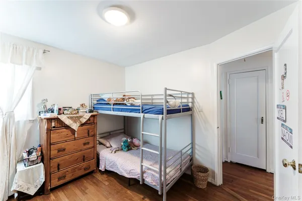 a bedroom with a bunk bed and a dresser