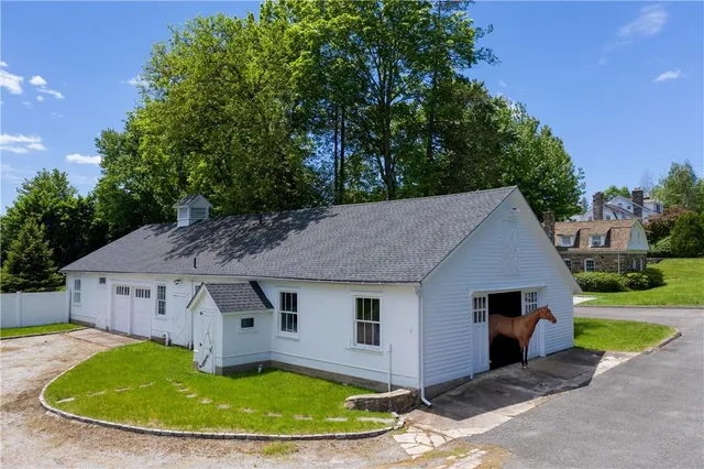 a aerial view of a house with a yard table and chairs