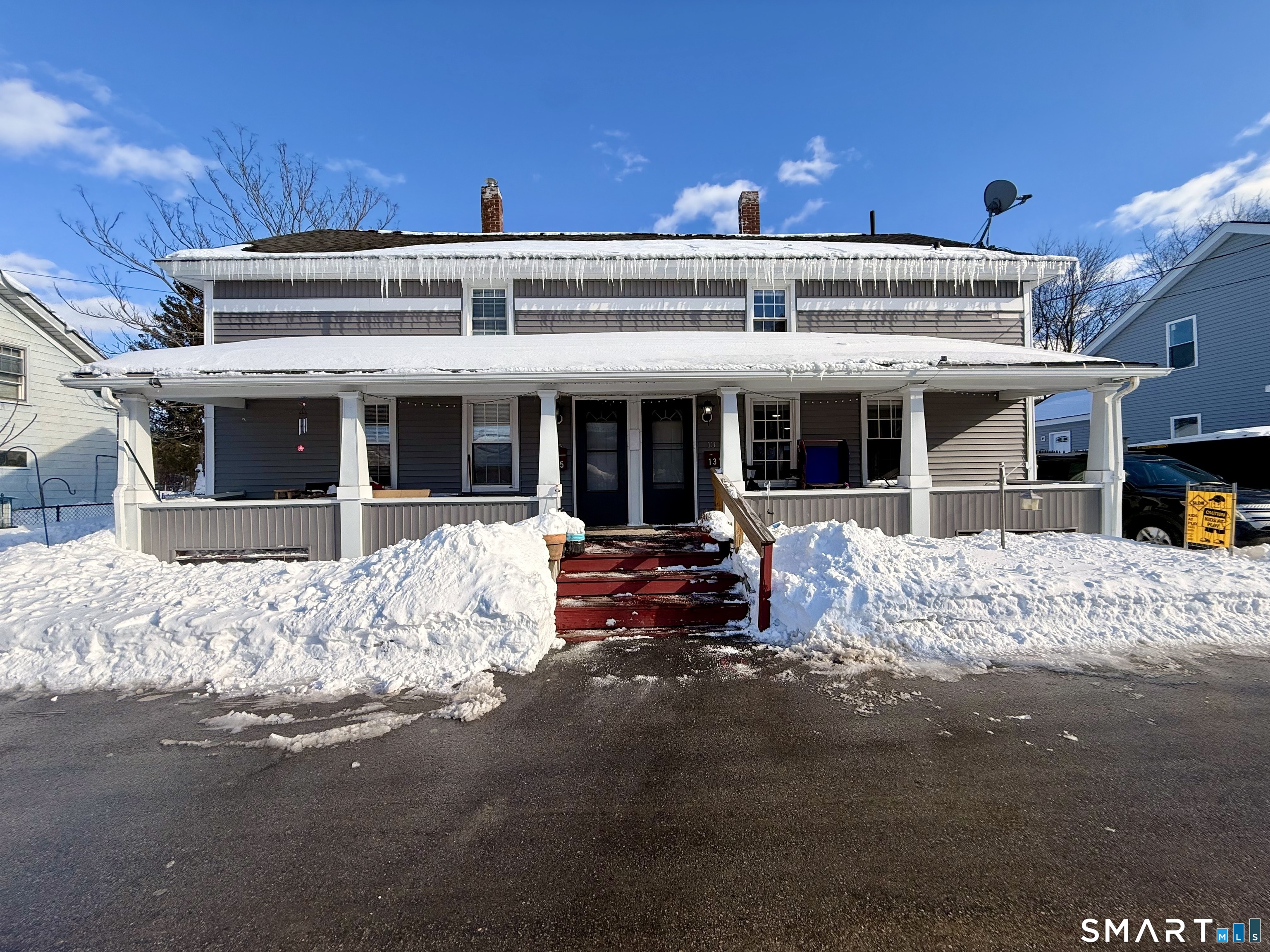 13 Mohegan Street Putnam, CT 06260 - Photo 1 of 1 a view of a building with the couches and large windows