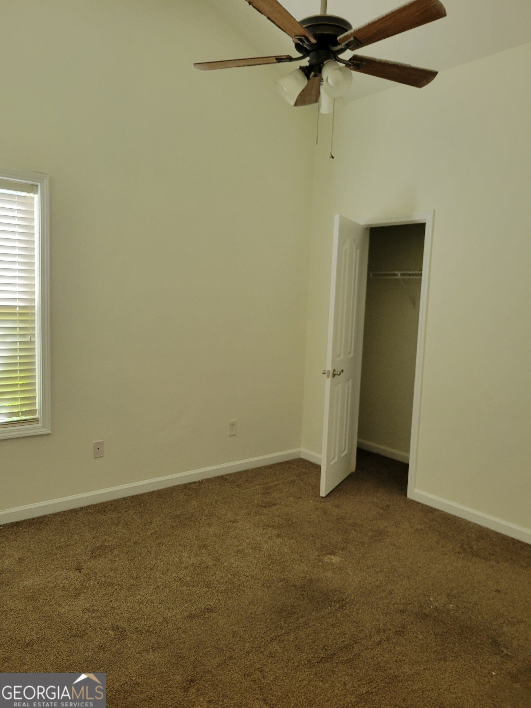 175 Spinner Drive Jefferson, GA 30549 - Photo 22 of 34 an empty room with a ceiling fan and a window