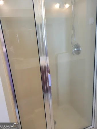 a bathroom with a glass door shower and sink