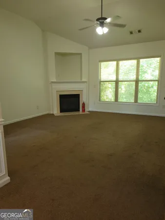 a view of empty room with a fireplace