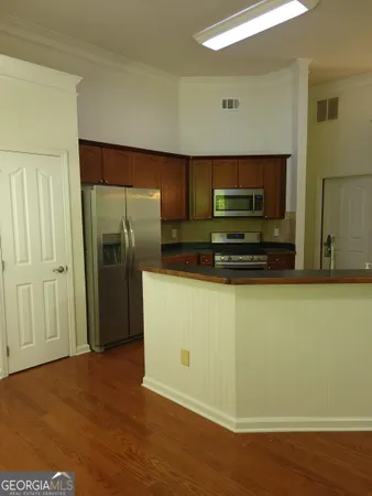 a view of kitchen cabinets and wooden floor