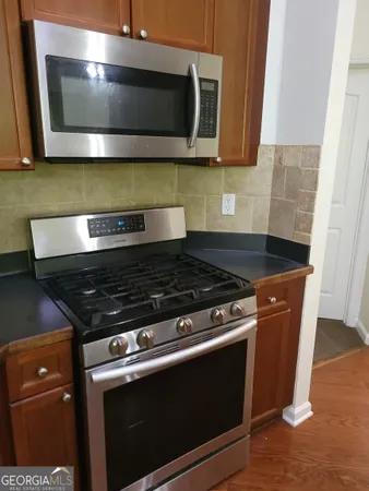 a stove top oven sitting inside of a kitchen