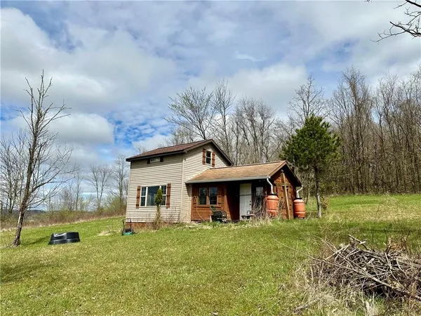 a view of a house with a yard and sitting area