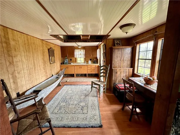 a living room with furniture ceiling fan and a large window