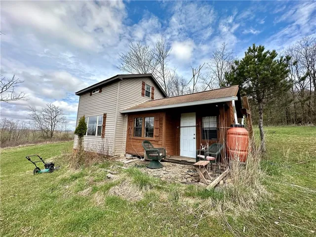 a backyard of a house with table and chairs