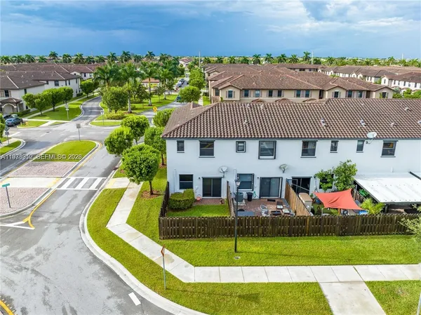 an aerial view of a house with swimming pool patio and lake view