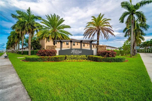 a couple of palm trees in front of house