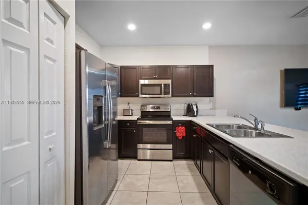 a kitchen with a sink stove and refrigerator