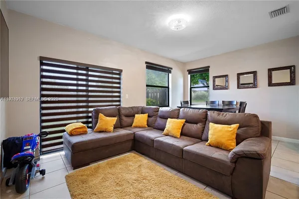 a living room with furniture and a large window
