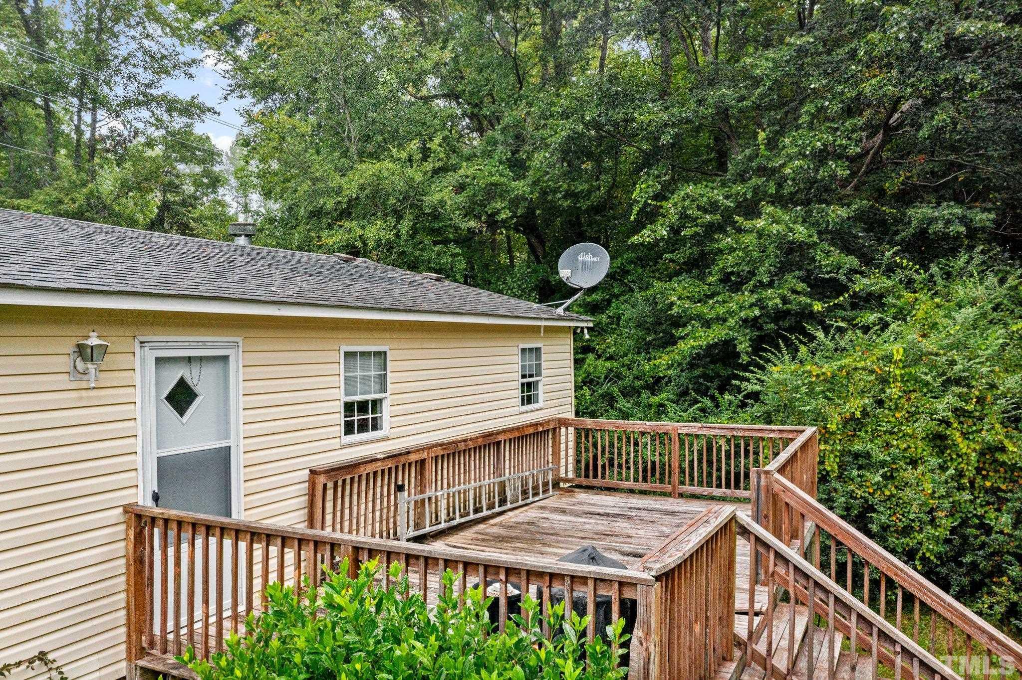 9617 Jernigan Road Spring Hope, NC 27882 - Photo 11 of 41 a view of a wooden deck and a backyard