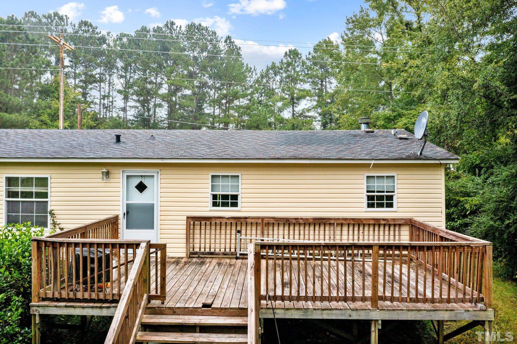 9617 Jernigan Road Spring Hope, NC 27882 - Photo 12 of 41 a view of a wooden deck and a yard