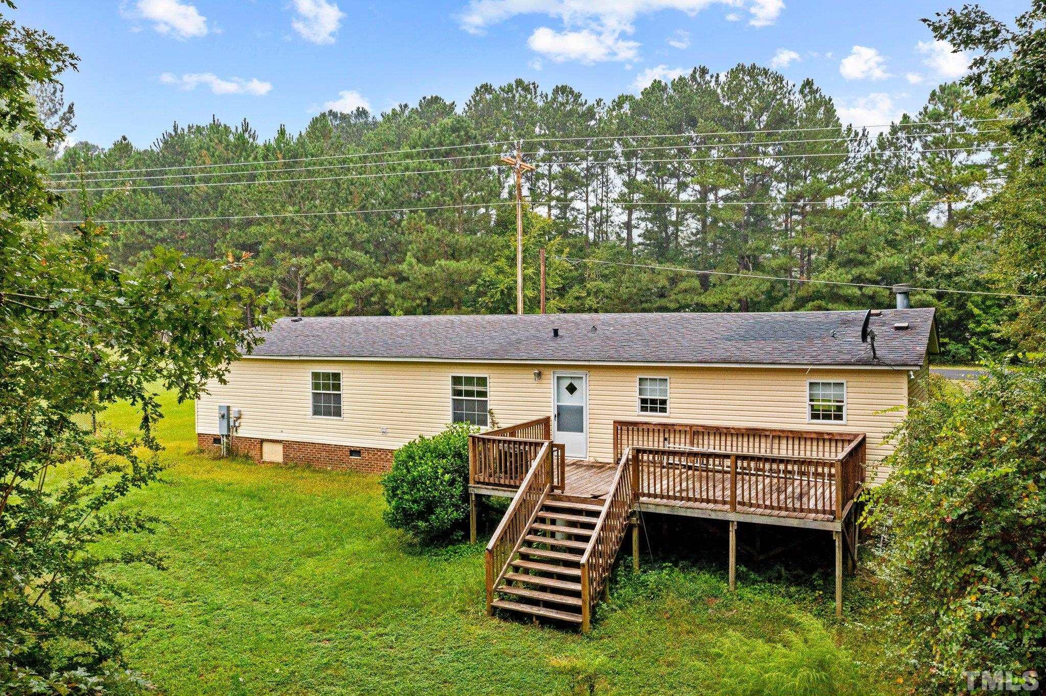 9617 Jernigan Road Spring Hope, NC 27882 - Photo 13 of 41 a view of a backyard with plants and a patio