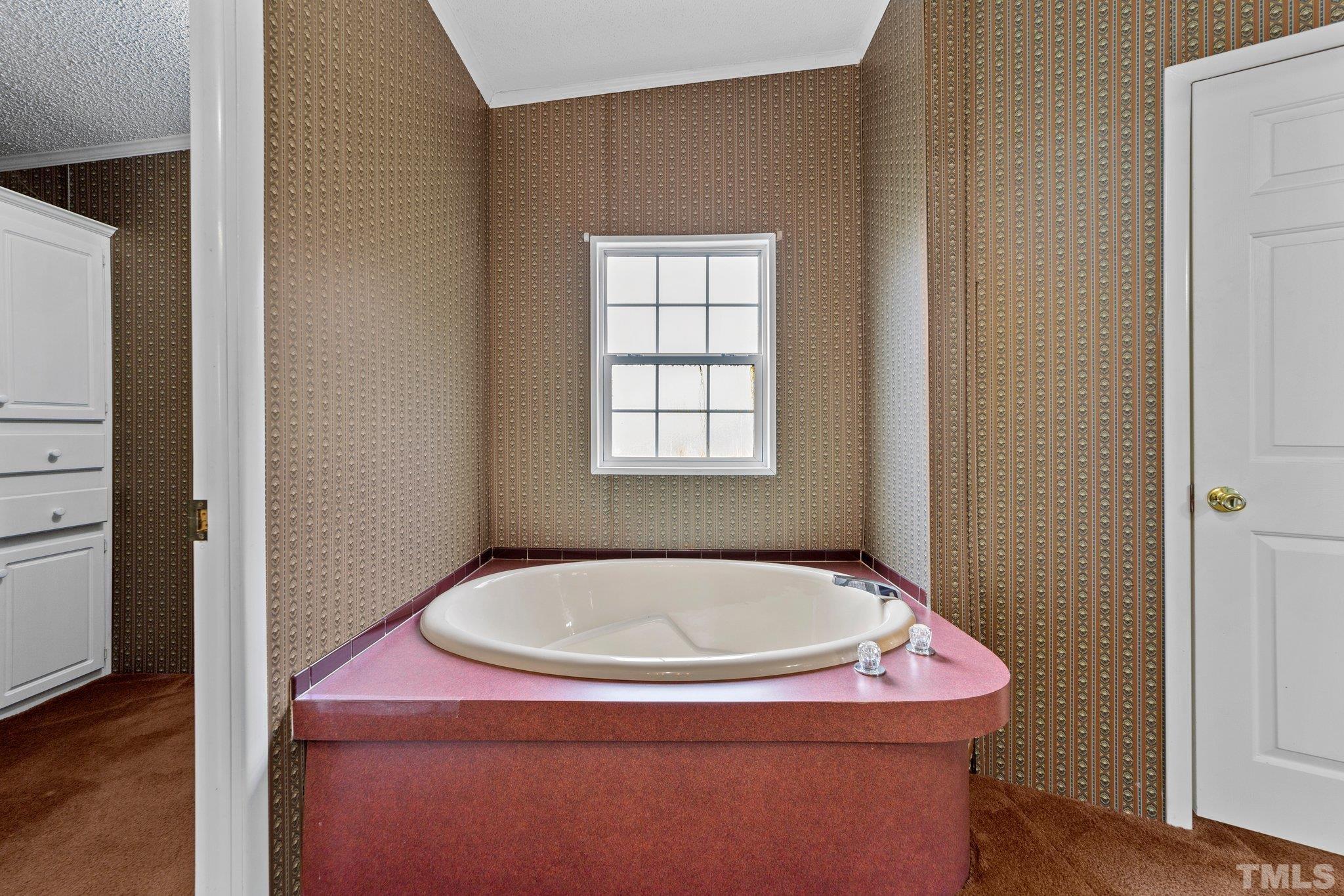 9617 Jernigan Road Spring Hope, NC 27882 - Photo 25 of 41 a bathroom with a tub and sink