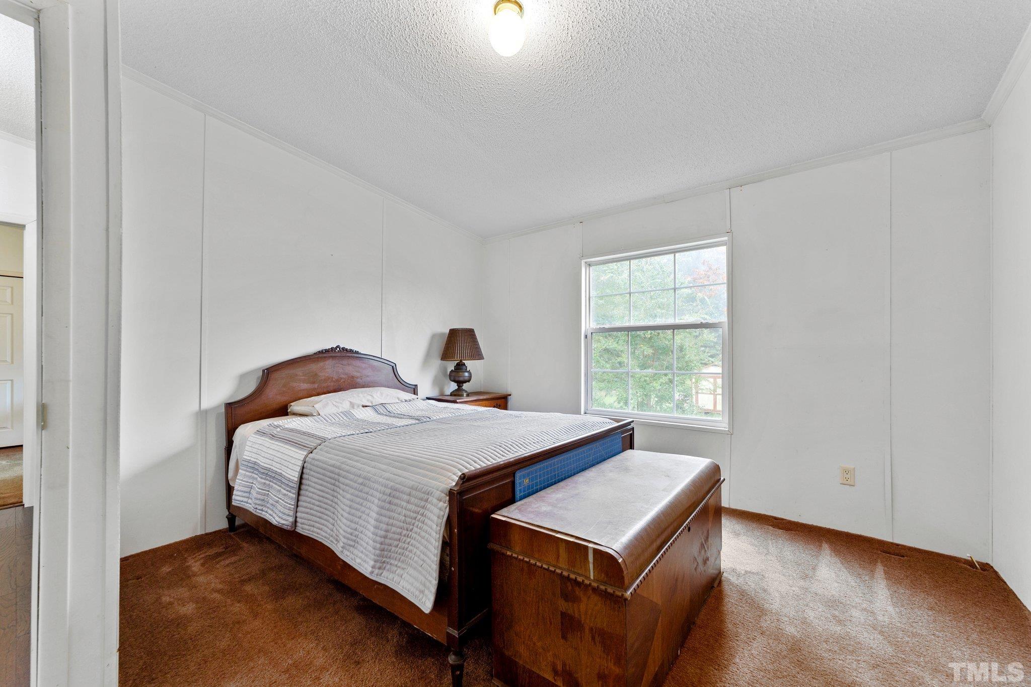 9617 Jernigan Road Spring Hope, NC 27882 - Photo 28 of 41 a bedroom with a bed and a window