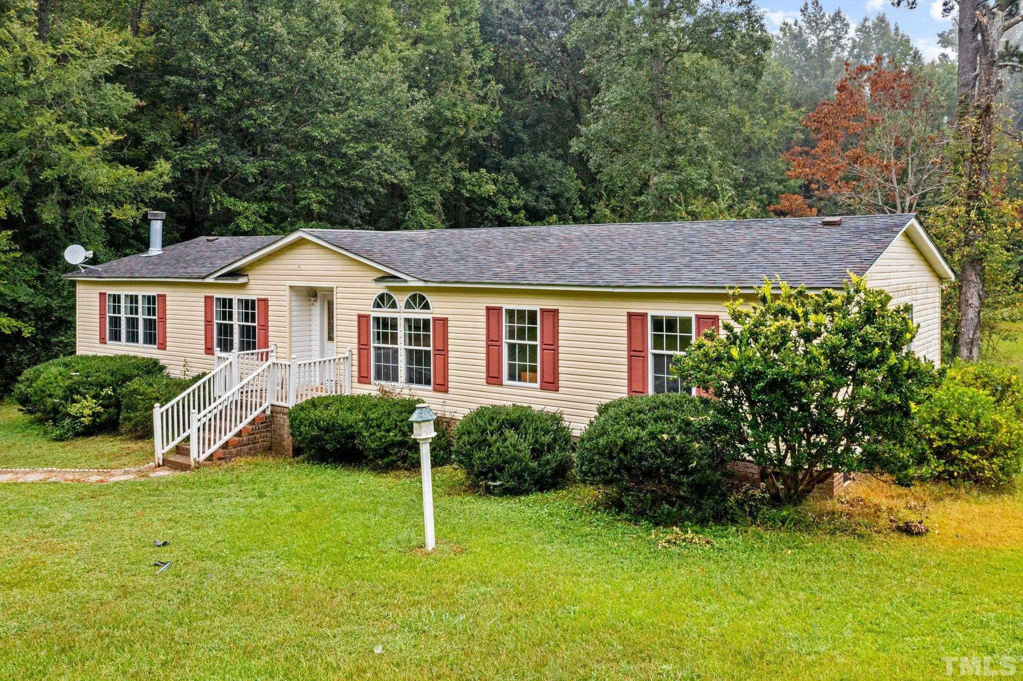 9617 Jernigan Road Spring Hope, NC 27882 - Photo 3 of 41 a front view of a house with a yard and trees