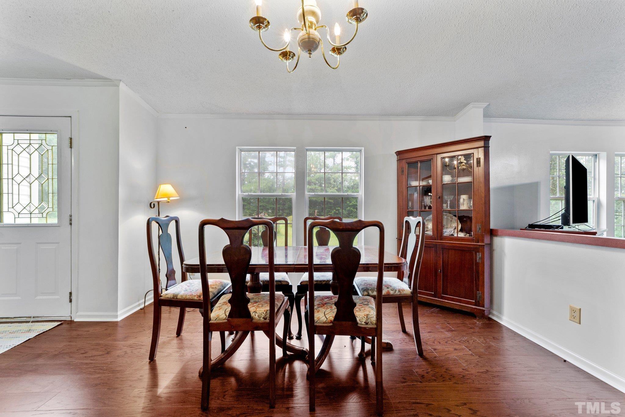 9617 Jernigan Road Spring Hope, NC 27882 - Photo 32 of 41 a view of a dining room with furniture window and wooden floor