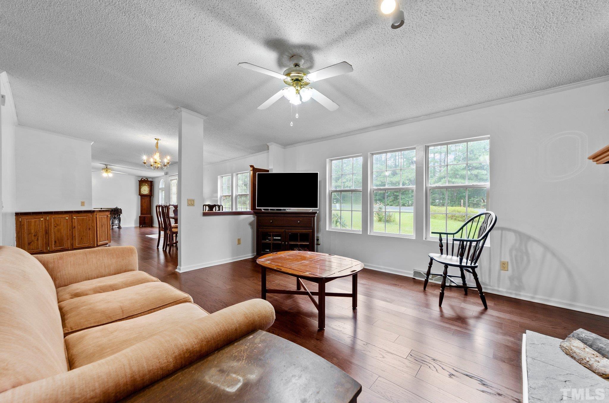 9617 Jernigan Road Spring Hope, NC 27882 - Photo 33 of 41 a living room with furniture and a flat screen tv with wooden floor