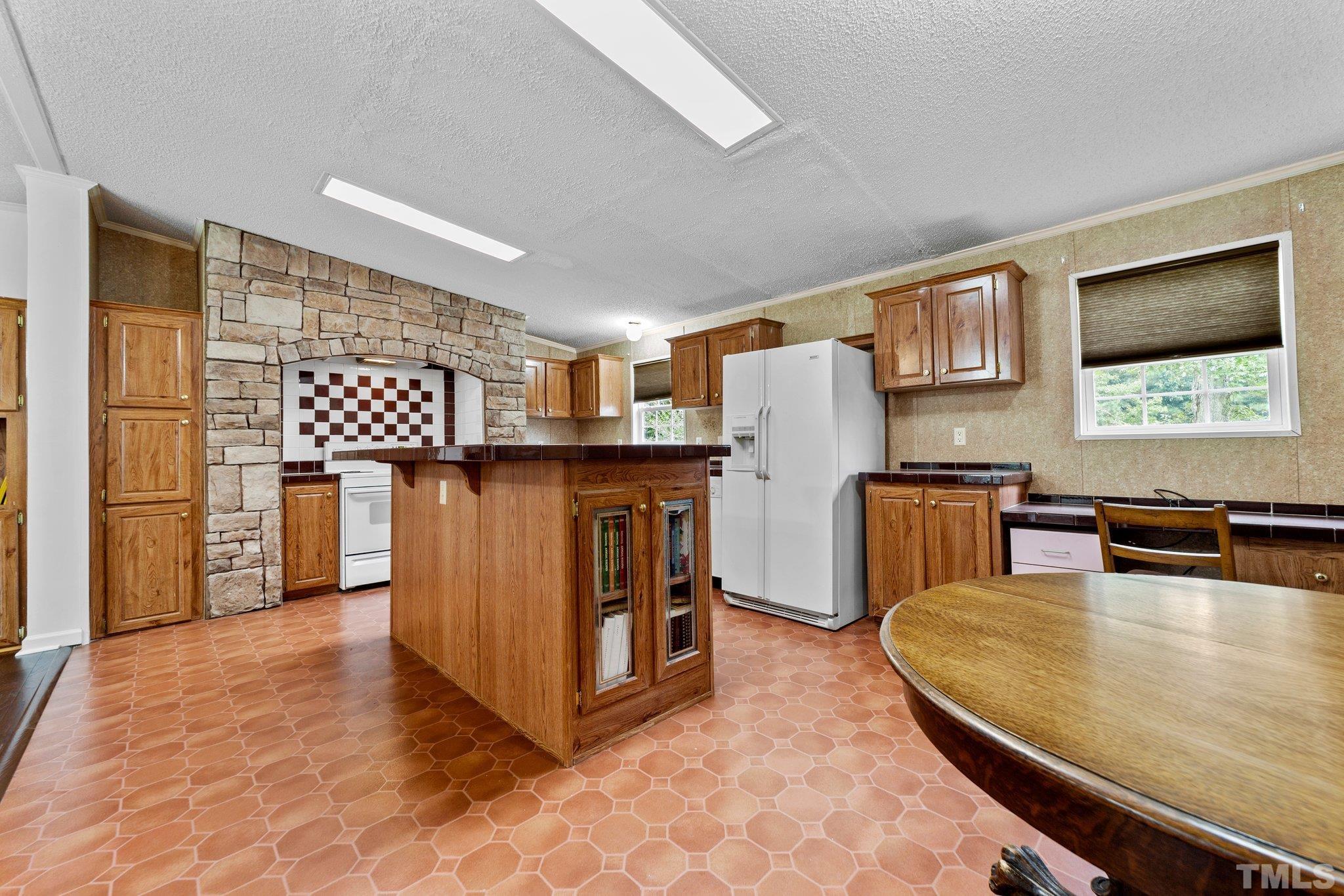 9617 Jernigan Road Spring Hope, NC 27882 - Photo 35 of 41 a living room with stainless steel appliances furniture a chandelier and a kitchen view