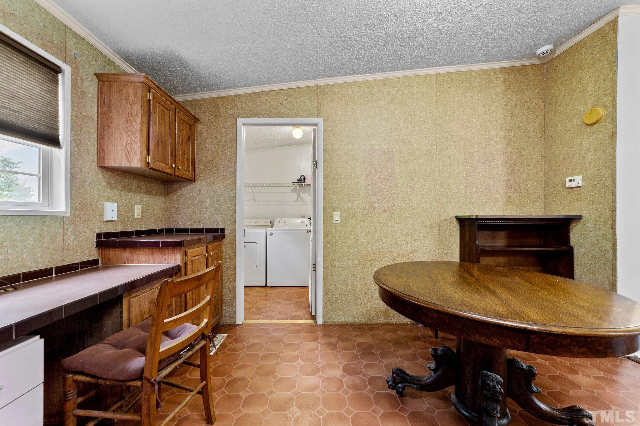 9617 Jernigan Road Spring Hope, NC 27882 - Photo 38 of 41 a room with table chairs and wooden floor