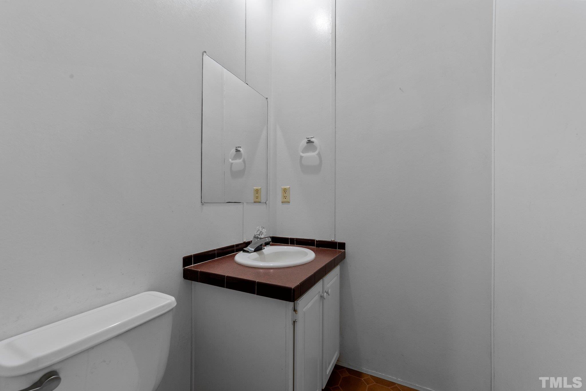 9617 Jernigan Road Spring Hope, NC 27882 - Photo 40 of 41 a bathroom with a sink toilet and vanity