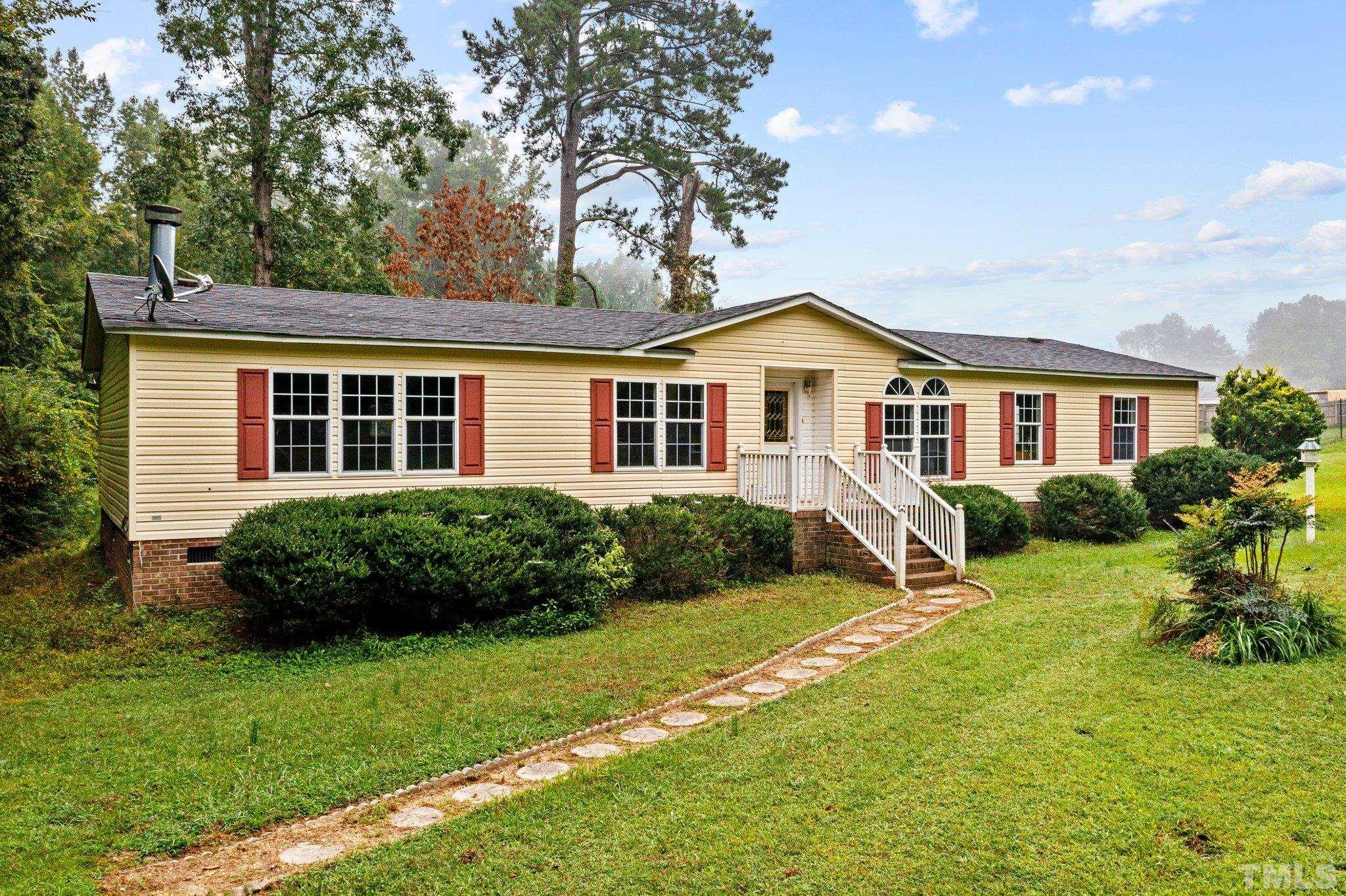 9617 Jernigan Road Spring Hope, NC 27882 - Photo 5 of 41 a view of a house with a yard and plants