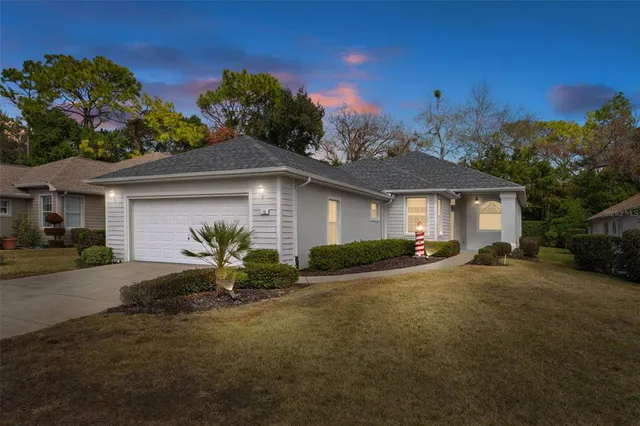 a front view of a house with a yard and outdoor seating