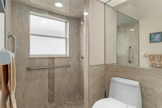 a front view of house with yard and trees around