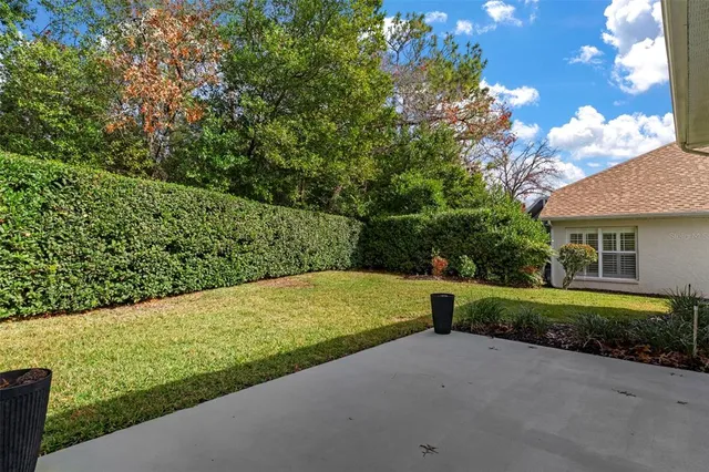 a view of a house with swimming pool and sitting area