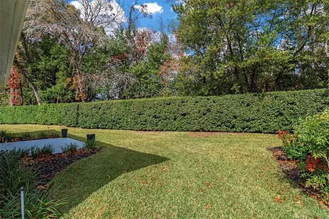 an aerial view of a house with a yard and garden